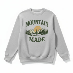 Oatmeal sweatshirt with 'Mountain Made' graphic on a light gray background