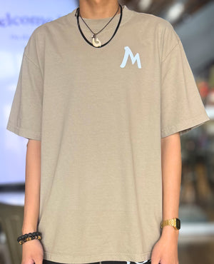 Tan Boxy Tee With White M Logo, Wearing Size LARGE.